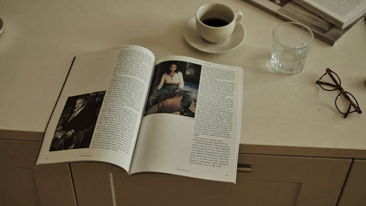 A community magazine on a kitchen counter beside a cup of tea